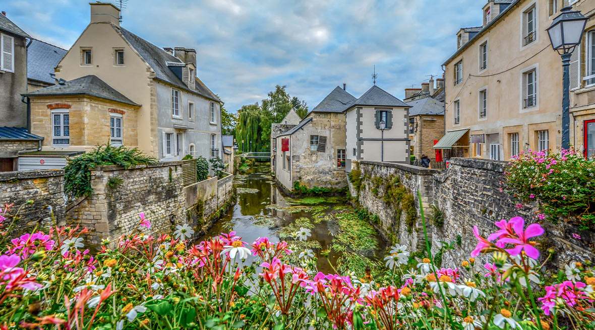 The picturesque French town of Bayeux France near the coast of Normandy with its medieval houses overlooking the River Aure on an overcast day
